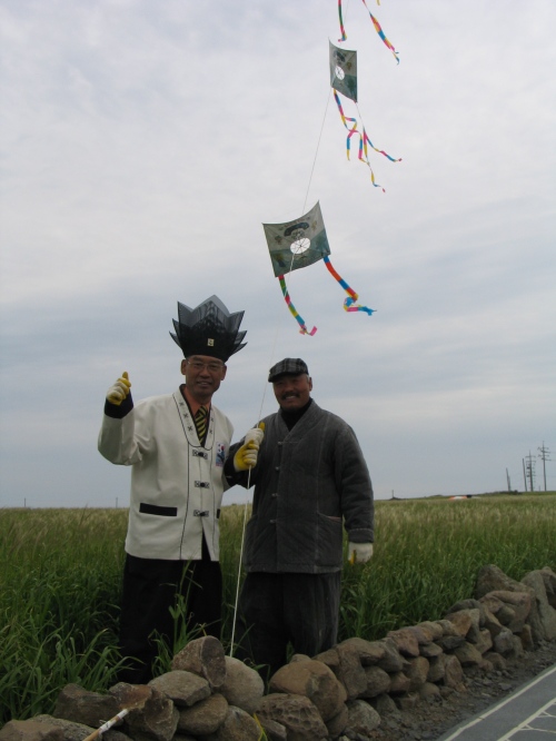 The fellow in the spiky hat, left is a shaman. I don't know why he was flying kites. 